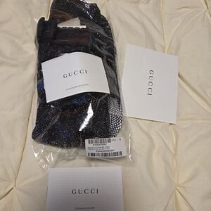GUCCI BLACK AND GOLD SPARKLE GG TIGHTS.